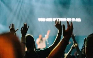 Hands raised in worship during a Sunday service
