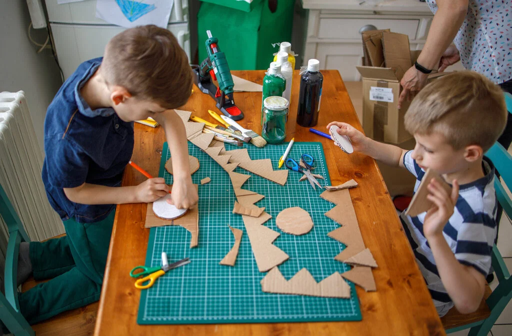Two boys doing cardboard crafts at Vacation Bible School