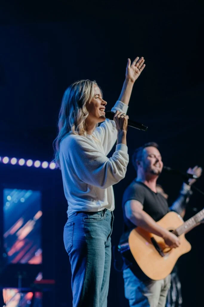 A worship leader sings at Common Ground Church