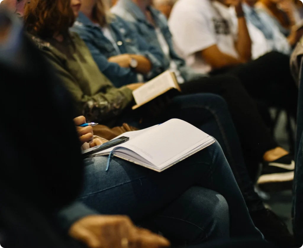 Close view of open notebooks and a Bible during a group study